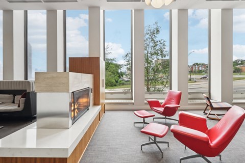 a living room with a fireplace and some chairs